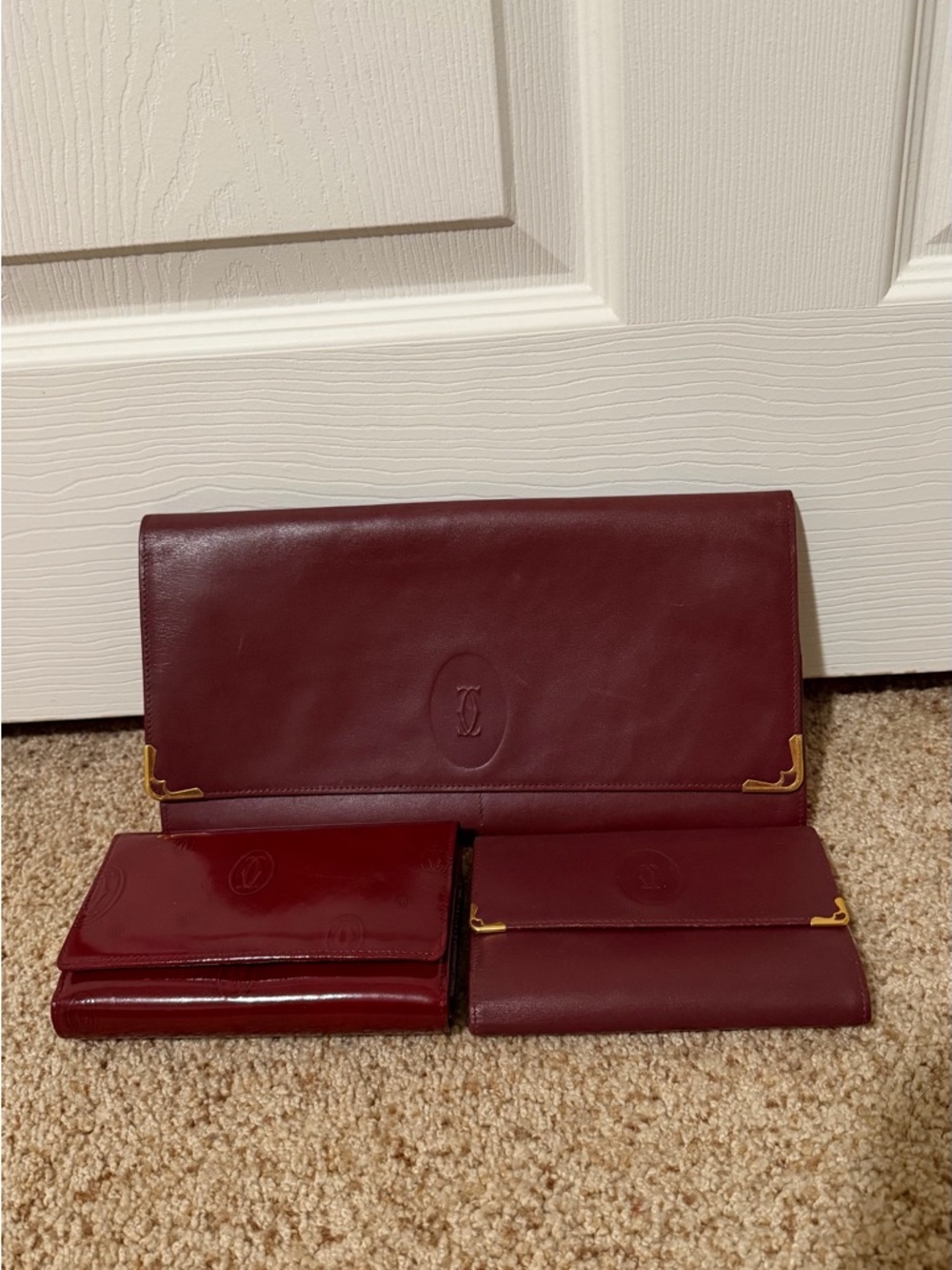 Bundle of 3. Cartier Burgundy Leather Clutch and 2 Wallets.
